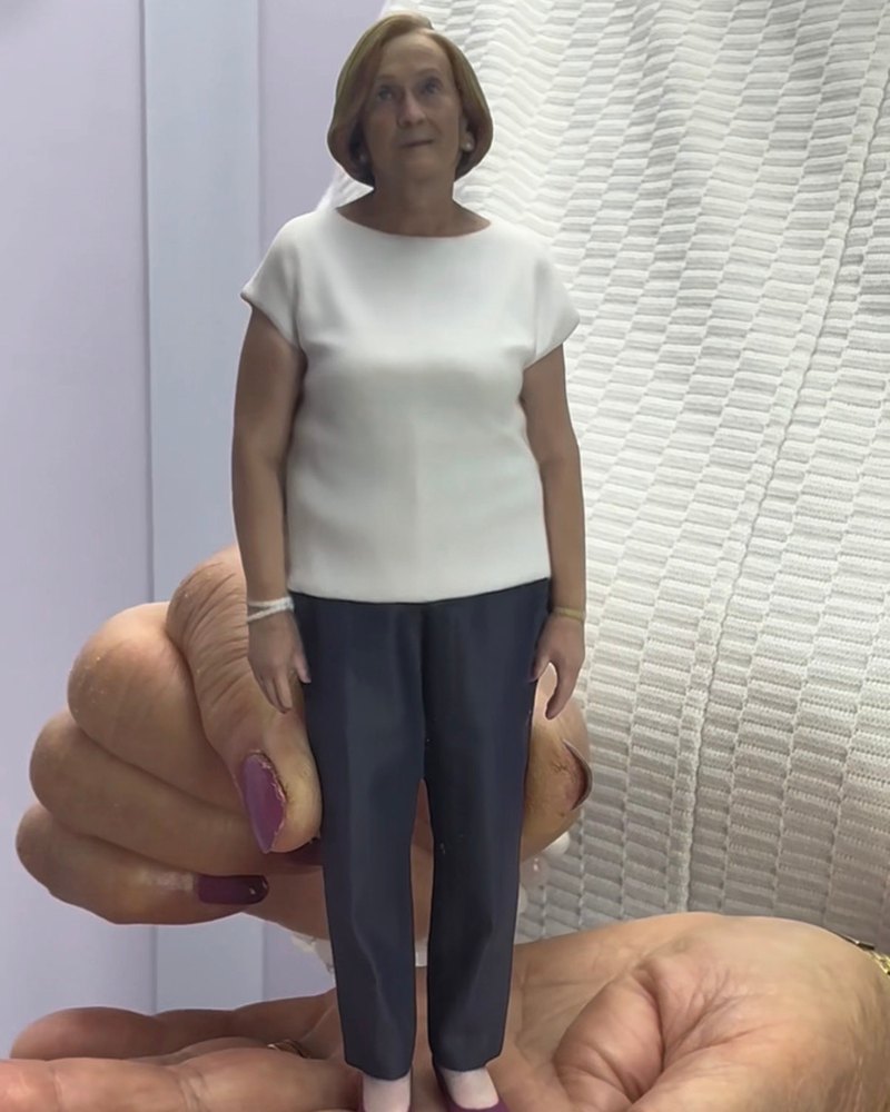 Mock-up 3D-printed figurine of a woman held in a palm